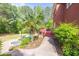 Serene backyard featuring a pool, hot tub, lush landscaping, and a charming brick pathway leading to the deck at 1459 Harris Rd, Lawrenceville, GA 30043