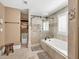 Bathroom featuring a tiled shower and tub combo and open shelving at 1459 Harris Rd, Lawrenceville, GA 30043