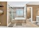 Bathroom with a separate shower, soaker tub, and neutral tiling at 1459 Harris Rd, Lawrenceville, GA 30043