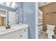 Powder room featuring a vanity with new fixtures, mirror, and toilet at 1459 Harris Rd, Lawrenceville, GA 30043