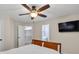 Bedroom with a ceiling fan, television, carpet floors, and a doorway to the bathroom at 1459 Harris Rd, Lawrenceville, GA 30043