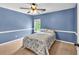 Comfortable bedroom with carpet floors, window and a patterned bedspread at 1459 Harris Rd, Lawrenceville, GA 30043