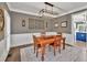 Classic dining room with wood furniture, designer lighting, and view to the kitchen at 1459 Harris Rd, Lawrenceville, GA 30043