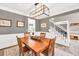 Formal dining room boasts decorative wainscoting, hardwood floors, and designer lighting at 1459 Harris Rd, Lawrenceville, GA 30043