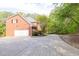 Exterior view of a brick home with a driveway and a two-car garage at 1459 Harris Rd, Lawrenceville, GA 30043