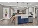 Modern open kitchen with a center island, stainless appliances, and view to the living room at 1459 Harris Rd, Lawrenceville, GA 30043