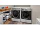Laundry area with modern washer and dryer and storage space at 1459 Harris Rd, Lawrenceville, GA 30043
