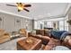 Inviting living room with comfortable seating, a ceiling fan, and open view to the kitchen at 1459 Harris Rd, Lawrenceville, GA 30043
