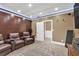 Home theater room with reclining seats, a textured ceiling, and wood accent wall at 1459 Harris Rd, Lawrenceville, GA 30043