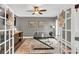 Stylish home office with French doors, a modern desk, and neutral decor for a productive workspace at 1459 Harris Rd, Lawrenceville, GA 30043