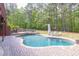 Gorgeous backyard with a pool, spa, lush landscaping, and a natural stone waterfall feature at 1459 Harris Rd, Lawrenceville, GA 30043