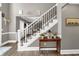 Elegant staircase featuring white railings, iron spindles, and hardwood flooring with a stylish decor at 1459 Harris Rd, Lawrenceville, GA 30043