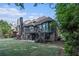 Expansive backyard features a lush lawn, mature trees, a deck and patio at 3574 N Druid Hills Rd, Decatur, GA 30033