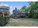 A spacious backyard includes a deck, patio, fence and plenty of green space at 3574 N Druid Hills Rd, Decatur, GA 30033
