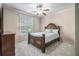 Bright bedroom with a large window, ceiling fan, and plush carpeting at 3574 N Druid Hills Rd, Decatur, GA 30033