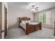 Comfortable bedroom with a ceiling fan and natural light from a large window at 3574 N Druid Hills Rd, Decatur, GA 30033