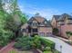Charming brick home featuring mature landscaping, symmetrical design, and a two-car garage at 3574 N Druid Hills Rd, Decatur, GA 30033