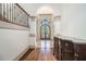 Grand foyer with arched doorway, hardwood floors, and elegant staircase with iron railing at 3574 N Druid Hills Rd, Decatur, GA 30033
