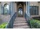 Stately brick home entrance with wrought iron railings and arched doorway at 3574 N Druid Hills Rd, Decatur, GA 30033