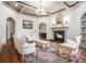 Elegant living room with fireplace, coffered ceilings, and ornate furniture at 3574 N Druid Hills Rd, Decatur, GA 30033