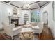 Bright living room with fireplace, coffered ceiling, and large windows overlooking the yard at 3574 N Druid Hills Rd, Decatur, GA 30033