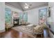 Cozy living room featuring a fireplace, hardwood floors, and abundant natural light at 3574 N Druid Hills Rd, Decatur, GA 30033