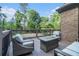 Outdoor deck with comfortable seating and table overlooking lush backyard at 3574 N Druid Hills Rd, Decatur, GA 30033