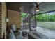 Covered outdoor living space with brick fireplace and comfortable seating at 3574 N Druid Hills Rd, Decatur, GA 30033