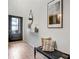 Modern entryway featuring light hardwood floors, a black front door, and stylish decor at 1233 Miss Irene Ln, Lawrenceville, GA 30044