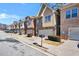 Street view of townhomes featuring brick exteriors, attached garages, and manicured landscaping at 1233 Miss Irene Ln, Lawrenceville, GA 30044