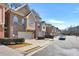 Charming townhome community featuring brick facades, attached garages, and well-maintained landscaping at 1233 Miss Irene Ln, Lawrenceville, GA 30044
