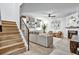 Open-concept living room with hardwood floors, wood stairs and plenty of natural light at 1233 Miss Irene Ln, Lawrenceville, GA 30044