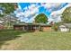 View of large backyard featuring brick home with a screened-in porch at 241 Burke Cir, Mcdonough, GA 30253