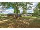 A home with a screened porch overlooks an expansive yard with many mature trees at 241 Burke Cir, Mcdonough, GA 30253