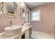Well-lit bathroom featuring double sinks with decorative mirrors and elegant countertops and marble floors at 241 Burke Cir, Mcdonough, GA 30253