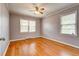 Bright bedroom featuring hardwood floors and dual windows for ample natural light at 241 Burke Cir, Mcdonough, GA 30253