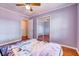 Comfortable bedroom with wood floors, closet and natural light, creating a serene space at 241 Burke Cir, Mcdonough, GA 30253