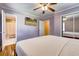 Comfortable bedroom with a ceiling fan, hardwood flooring, and a view into an attached bathroom at 241 Burke Cir, Mcdonough, GA 30253