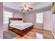 Cozy bedroom featuring a wooden bed frame, hardwood flooring, and two windows that bring in natural light at 241 Burke Cir, Mcdonough, GA 30253