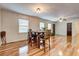 Bright dining area featuring a wooden table with seating for four and glossy hardwood flooring throughout at 241 Burke Cir, Mcdonough, GA 30253