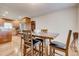 Well-lit dining area featuring a wooden table with black cushioned chairs and hardwood flooring throughout at 241 Burke Cir, Mcdonough, GA 30253