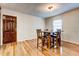 Inviting dining area featuring hardwood floors and a rustic wooden table, perfect for Gathering gatherings at 241 Burke Cir, Mcdonough, GA 30253