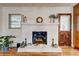 Charming living room featuring a classic white brick fireplace and hardwood flooring at 241 Burke Cir, Mcdonough, GA 30253