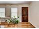 Welcoming entryway showcasing a wooden door and hardwood floors, providing a warm and inviting feel at 241 Burke Cir, Mcdonough, GA 30253