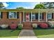 Traditional brick ranch with well-maintained landscaping and a bright red door at 241 Burke Cir, Mcdonough, GA 30253