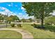 Expansive front yard and sidewalk with mature trees around a traditional brick home at 241 Burke Cir, Mcdonough, GA 30253