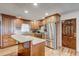 Charming kitchen featuring wood cabinets, stainless steel appliances, granite countertops, and hardwood flooring at 241 Burke Cir, Mcdonough, GA 30253