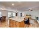 Open concept kitchen and living room featuring hardwood floors, granite countertops, and stainless appliances at 241 Burke Cir, Mcdonough, GA 30253