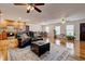 Open-concept living space with hardwood floors, seamlessly connecting the kitchen, dining area, and living room at 241 Burke Cir, Mcdonough, GA 30253