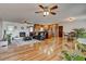Open-concept living room with hardwood floors, a fireplace, and seamless flow to the kitchen and dining area at 241 Burke Cir, Mcdonough, GA 30253